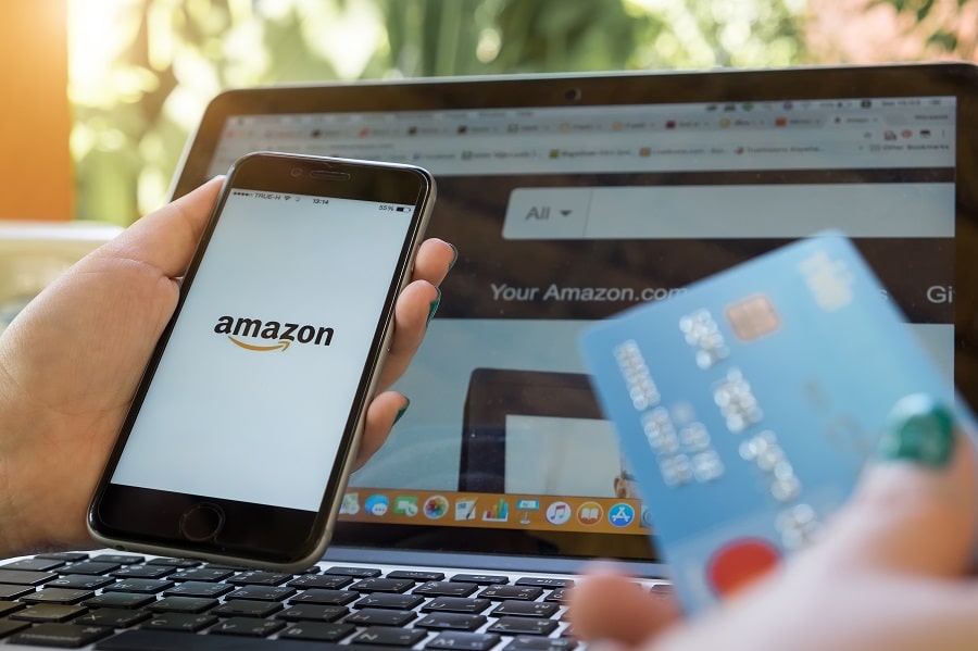 A person using a credit or debit card to make a payment on Amazon